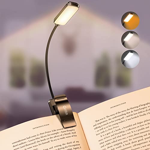 Luz de lectura Gritin encendida con distintos modos de luz sobre un libro
