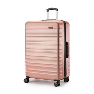 Maleta rígida de Amazon Basics en color oro rosa con diseño moderno y 4 ruedas giratorias, ideal para viajes.
