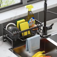 Organizador de fregadero de cocina con esponjas, detergentes y trapos en uso, ideal para mantener el área de la cocina ordenada.